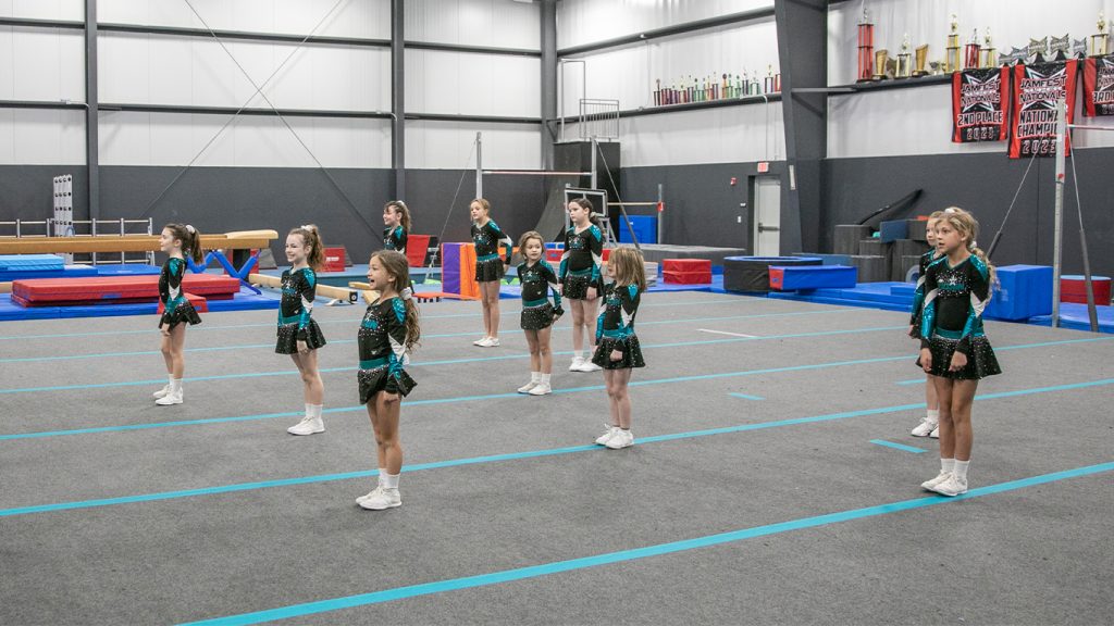 Cheerleaders standing in formation on cheer floor at Community Sports and Wellness in Pendleton, Indiana.